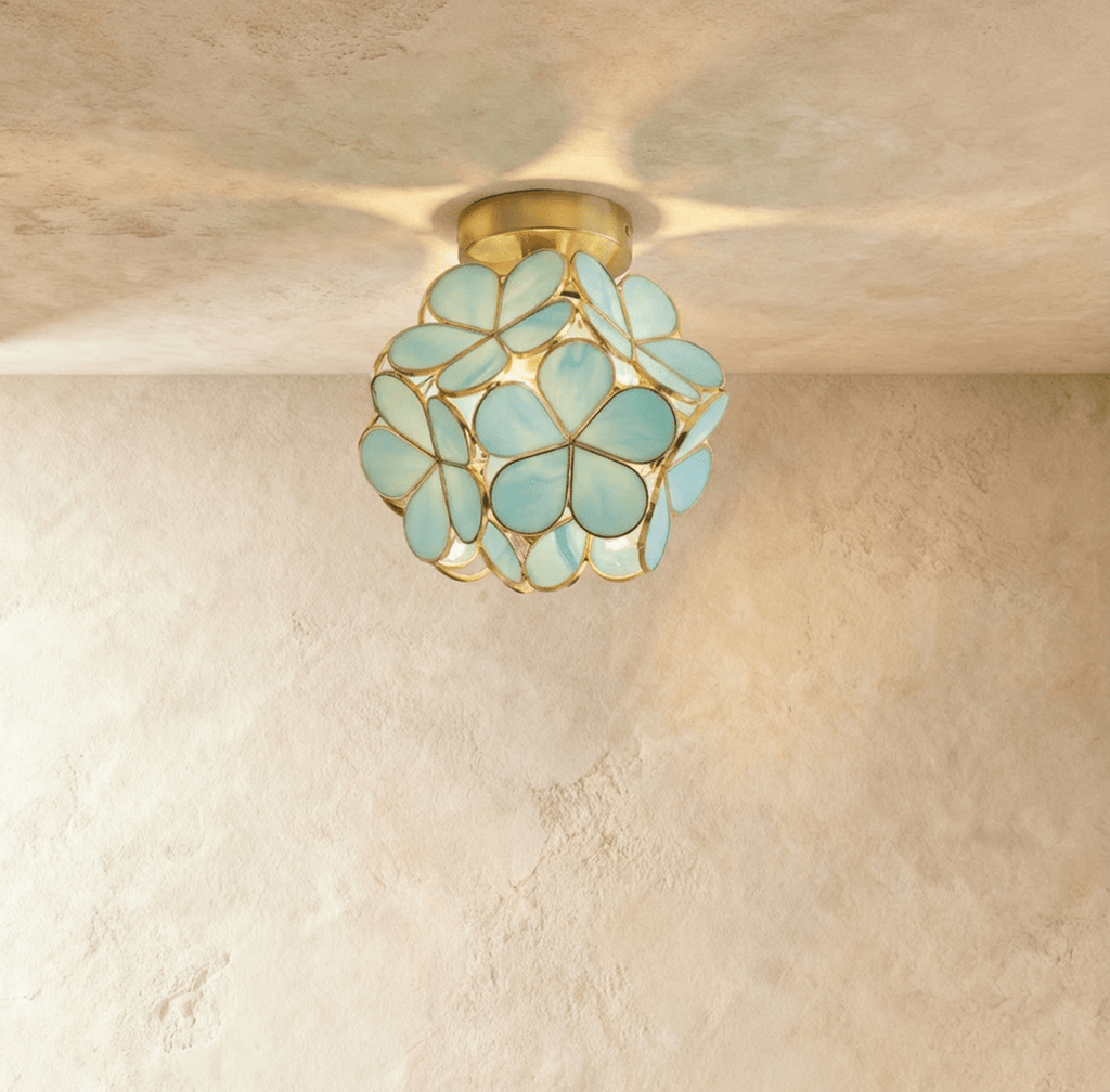 Golden teardrop cluster ceiling light fixture with warm amber glass on white ceiling in modern hallway.
