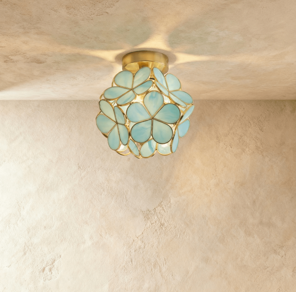 Golden teardrop cluster ceiling light fixture with warm amber glass on white ceiling in modern hallway.