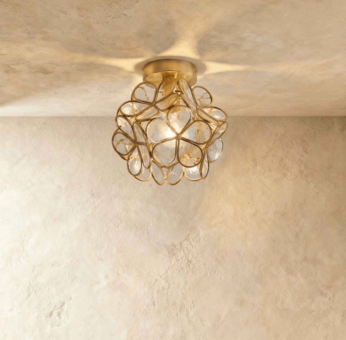 Gold petal-shaped ceiling light fixture mounted on white ceiling in modern bathroom interior