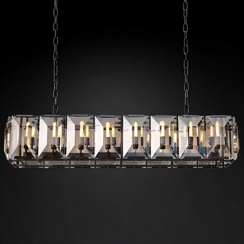 Linear chandelier with brushed nickel finish and geometric crystal panels, suspended against a black background.