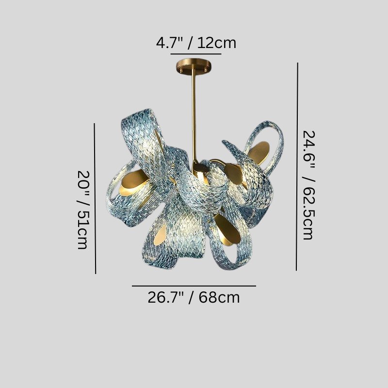 Modern chandelier with textured blue and white ribbons, brass accents, and warm interior lighting on gray background.
